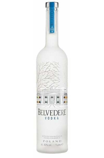 a bottle of Belvedere Vodka with glasses, lemon and ice around