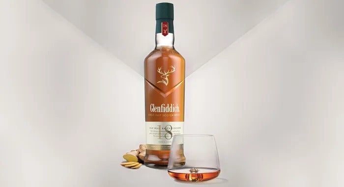 Bottle of Glenfiddich 18 year next to a tumbler glass of whisky