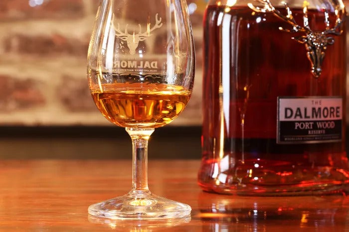 Glass of Dalmore whisky next to a bottle of Dalmore Port Wood single malt