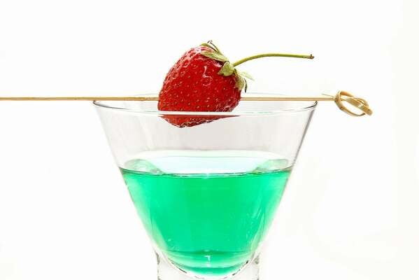 green grinch cocktail in the a tall cocktail